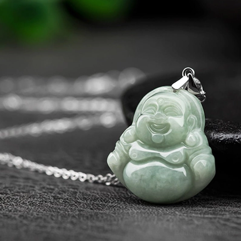 Laughing Buddha jade pendant side overhead shot with plump smiling Buddha carved pale green jade texture metal hanging buckle and silver chain