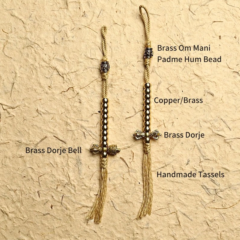 Handcrafted mala bead accessories including copper dorje counter and decorative tassels components