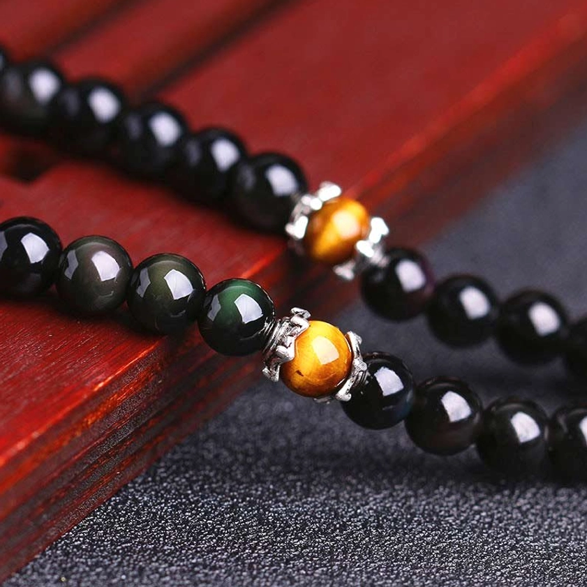 Buddhist mala beads close up alternating black obsidian tiger eye bead pattern detail