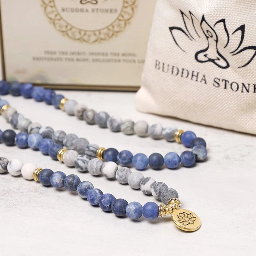 Mala bead jewelry collection with Picasso Jasper bracelet, branded packaging and canvas dust bag, multiple blue stone pieces