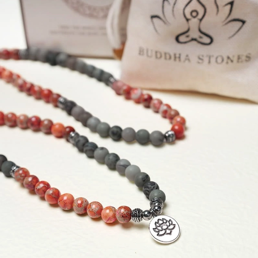 Folded 108 mala bead strand with Buddha Stones pouch showing packaging and presentation