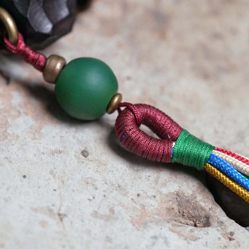 Matte green accent bead with wrapped fabric knot and multicolor silk tassel - mala connector