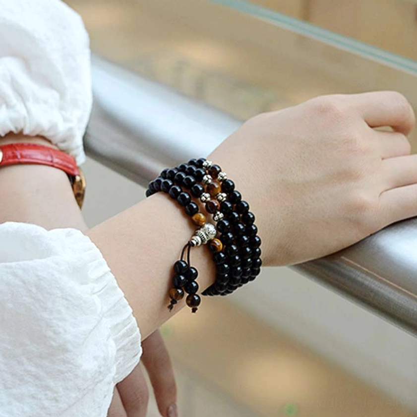 Black obsidian tiger eye mala bracelet worn on wrist, showing proper fit and natural light detail