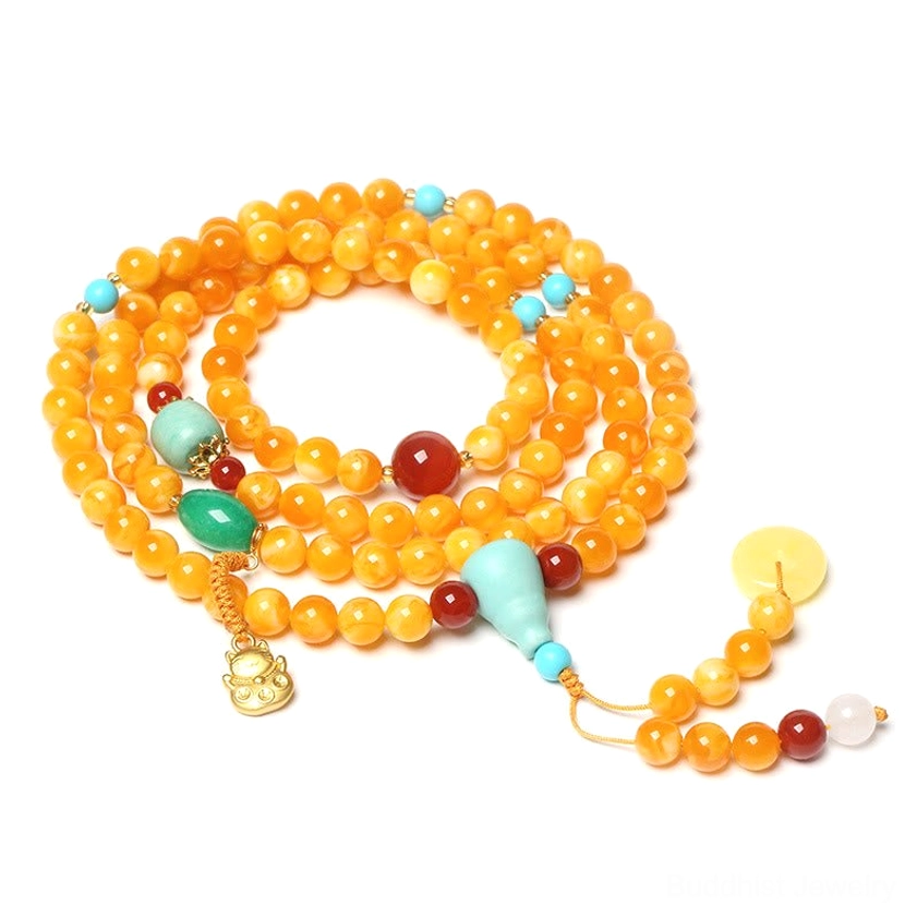 108 bead amber mala circular loop with turquoise, red agate, jade peace buckle and gold pendant on white background