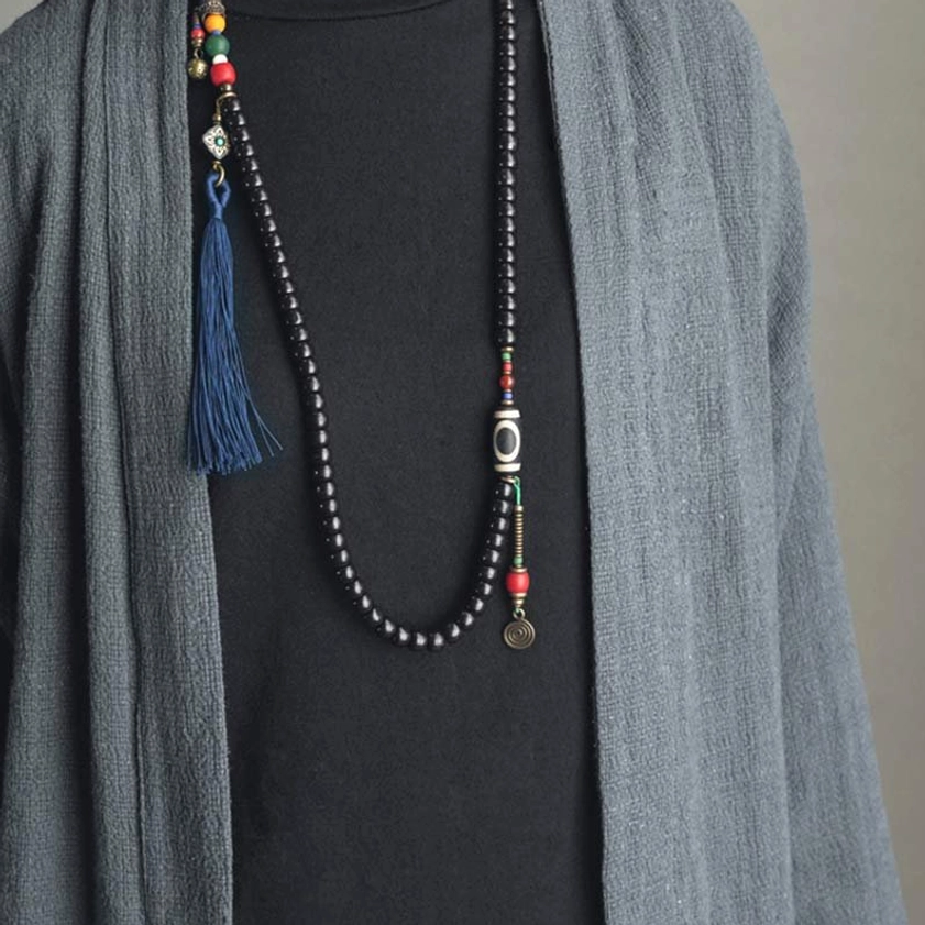 108 bead mala necklace front close-up with ebony wood beads, dzi bead, and brass pendant detail