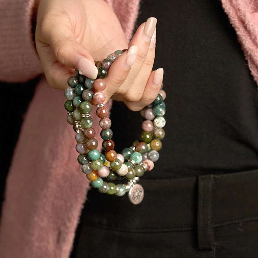Handmade 108 Indian agate mala bracelet with lotus pendant worn on wrist in daily casual setting