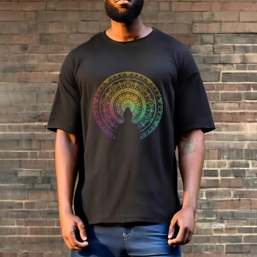 Full body front view of man wearing mandala Buddha gradient t-shirt with crew neck and rainbow mandala print against brick wall outdoor