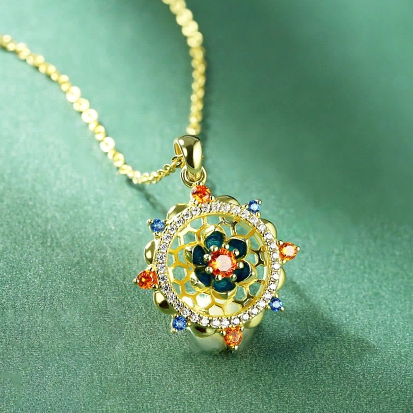 Detailed view of lotus pendant with vibrant multicolor cubic zircons and intricate hollow-carved silver design