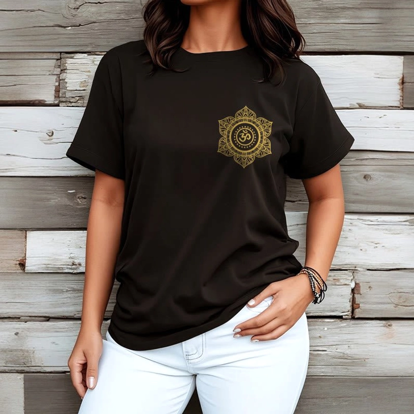 Woman wearing black Buddhist mandala OM t-shirt with gold print wooden background