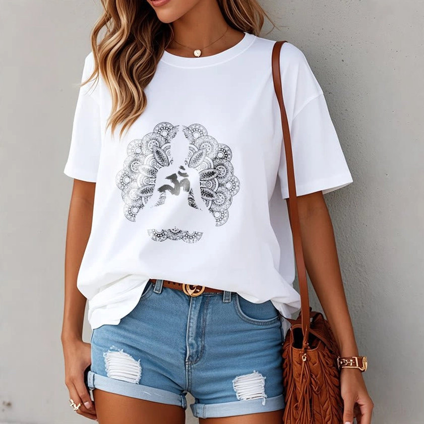 Woman wearing white mandala om buddhist t-shirt paired with denim shorts indoor