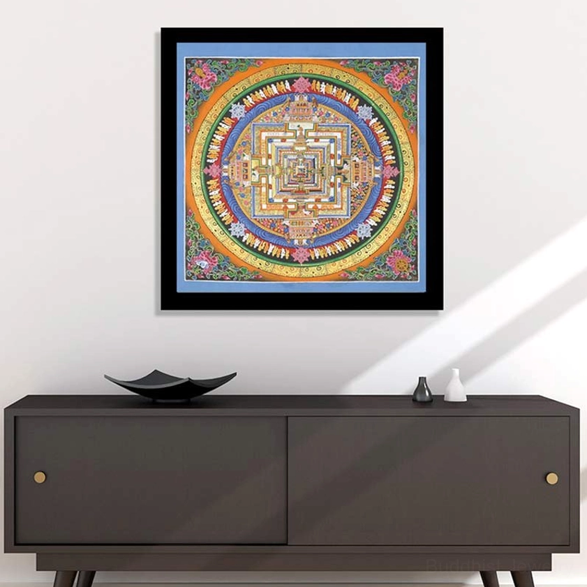 Framed Kalachakra Mandala Thangka displayed on living room wall above dark wooden sideboard, Buddhist home meditation decor