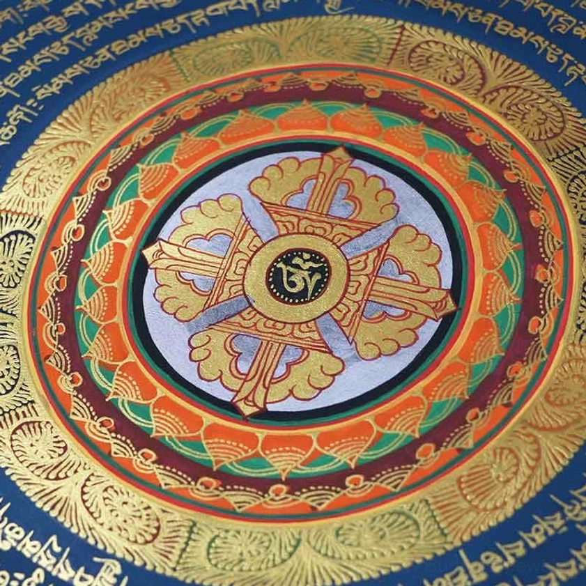 Close-up detail of intricate vajra mandala thangka featuring golden cross center, layered lotus borders, and Tibetan script – handmade Buddhist spiritual artwork