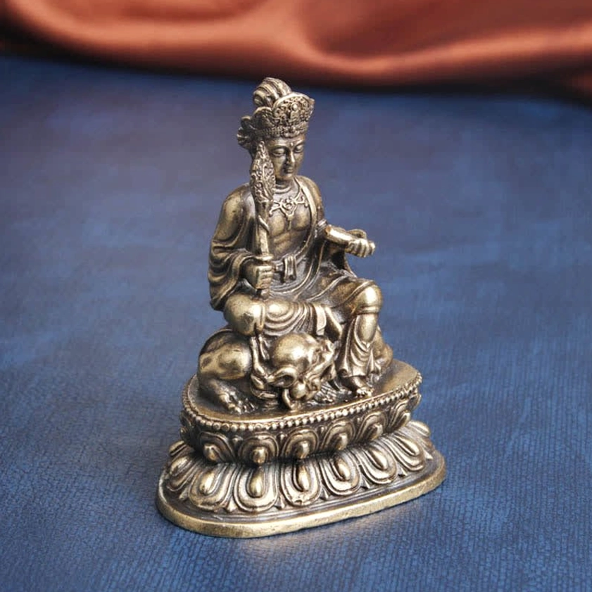Three-quarter side angle of hand-carved Manjusri statue displaying detailed robe textures, antique bronze patina finish, and ornamental headdress - artisan crafted Buddhist wisdom deity