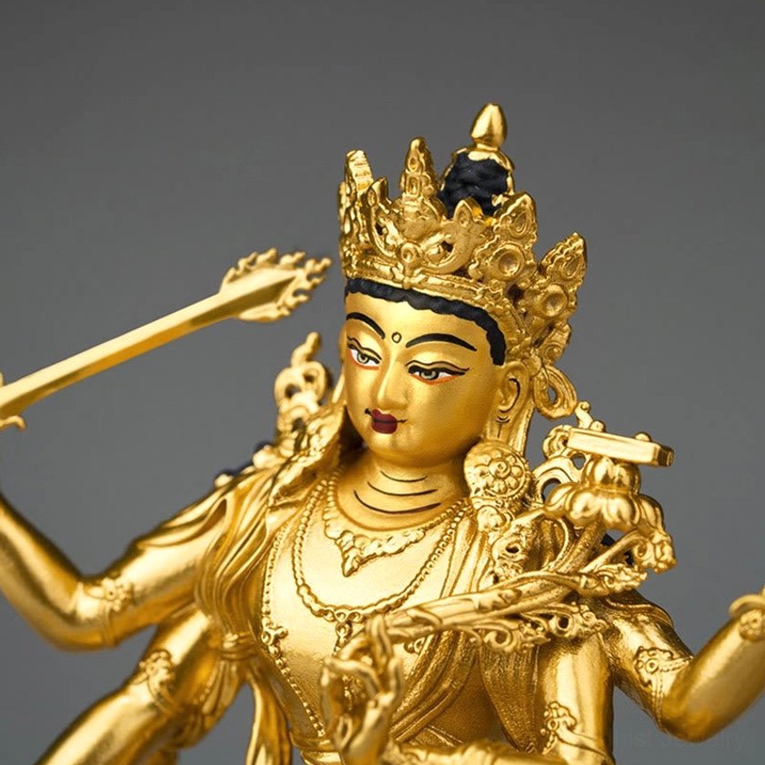 Manjusri Bodhisattva statue head and upper body close-up showing ornate crown and facial features