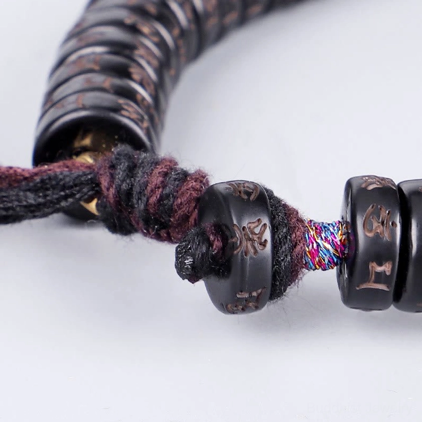 Bracelet clasp and woven tassel closure detail with colorful braided cord and metal spacer