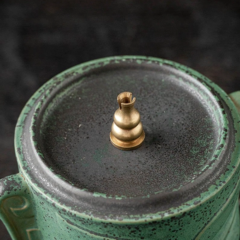 Ceramic incense burner in meditation room setting, demonstrating usage for Buddhist practice and mindfulness rituals