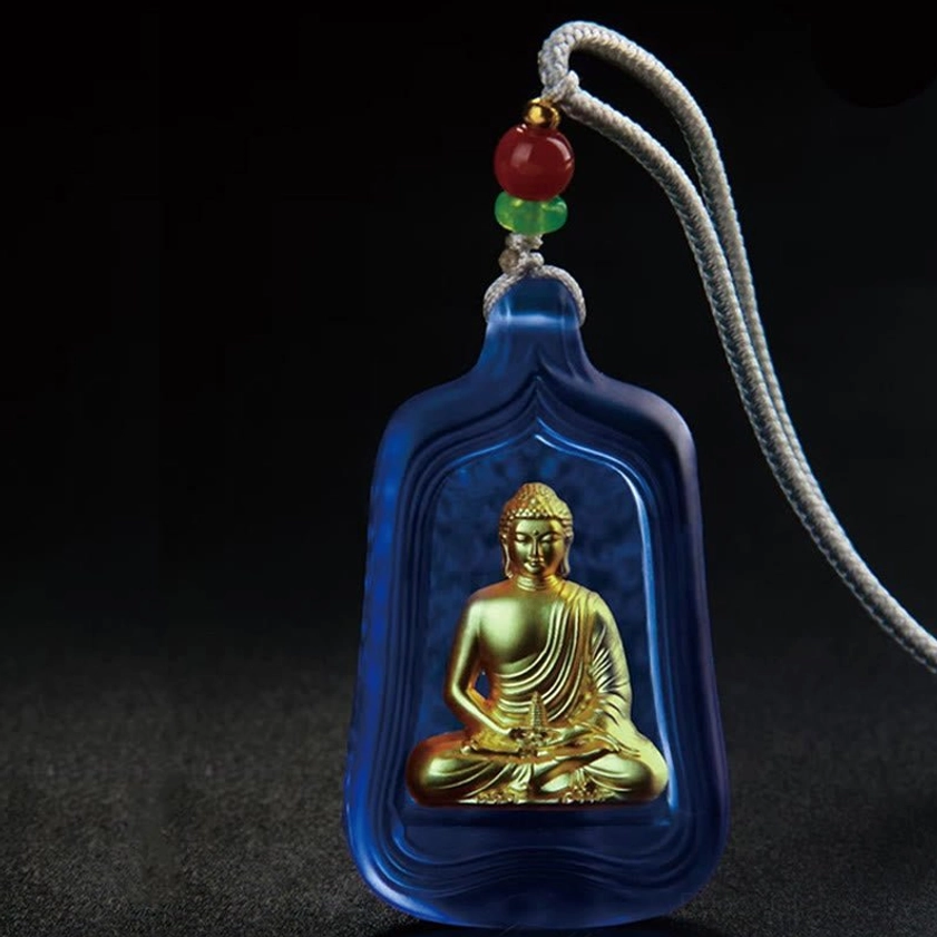 Medicine Buddha Buddhist pendant necklace with blue frosted glass case, gold Buddha figure, and gray braided cord - front view