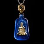 Blue Medicine Buddha Liuli crystal pendant with gold seated Buddha figure and metal clasp - front studio view