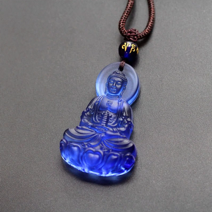 Blue Liuli crystal Medicine Buddha necklace pendant featuring tranquil deep blue translucent glass Buddha with decorative beaded cord, spiritual healing jewelry