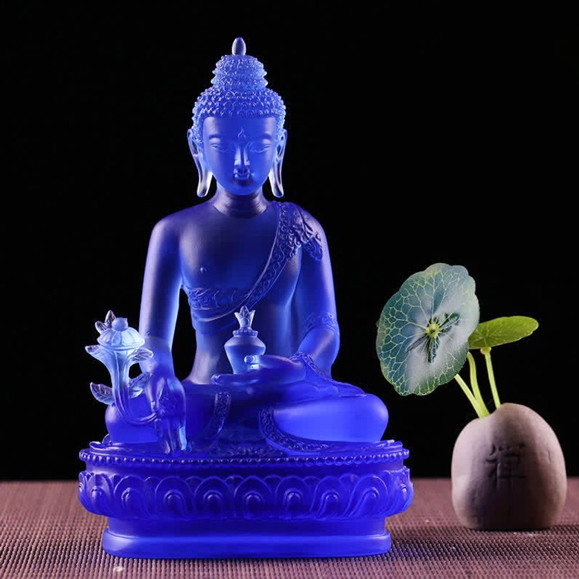 Medicine Buddha Liuli crystal art piece with solid deep blue glass, holding ritual implements, on lotus pedestal with zen decor