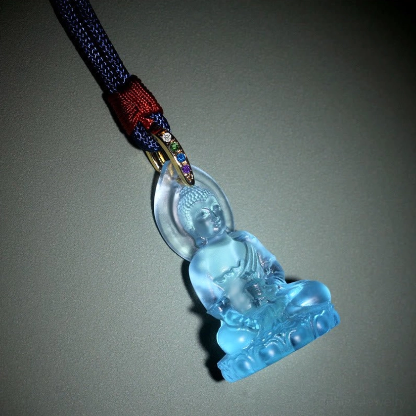 Light blue translucent Medicine Buddha necklace pendant oblique view showing lotus throne design