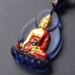Blue Gold Medicine Buddha Liuli crystal pendant with gilded accents and dark blue leaf frame on luxury cord necklace