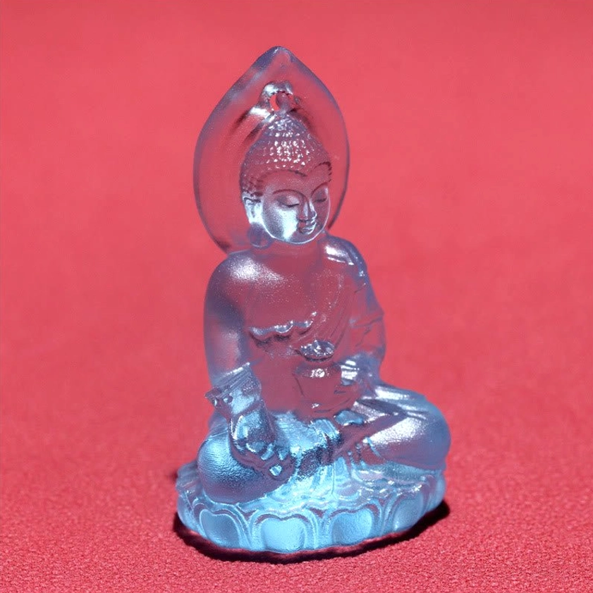 Close-up front view of blue Medicine Buddha Liuli crystal pendant showing detailed Buddha face and lotus base