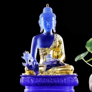 Medicine Buddha Liuli crystal statue front view with deep blue glass body, gilded robe, and lotus pedestal in studio setting