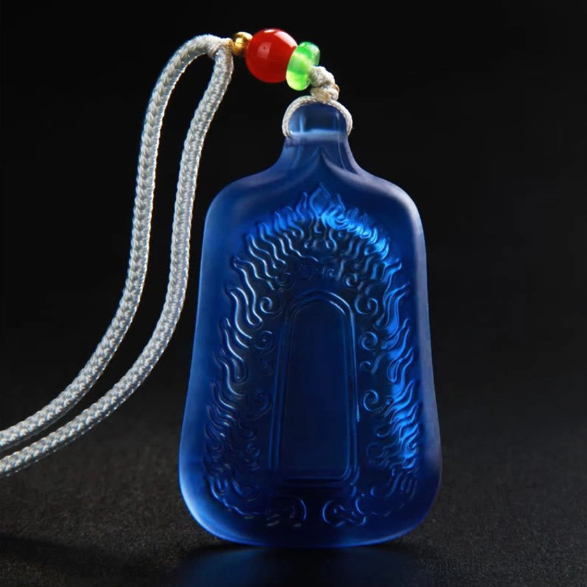 Blue Medicine Buddha pendant back cover showing frosted glass and flame pattern engraving with beaded cord attachment