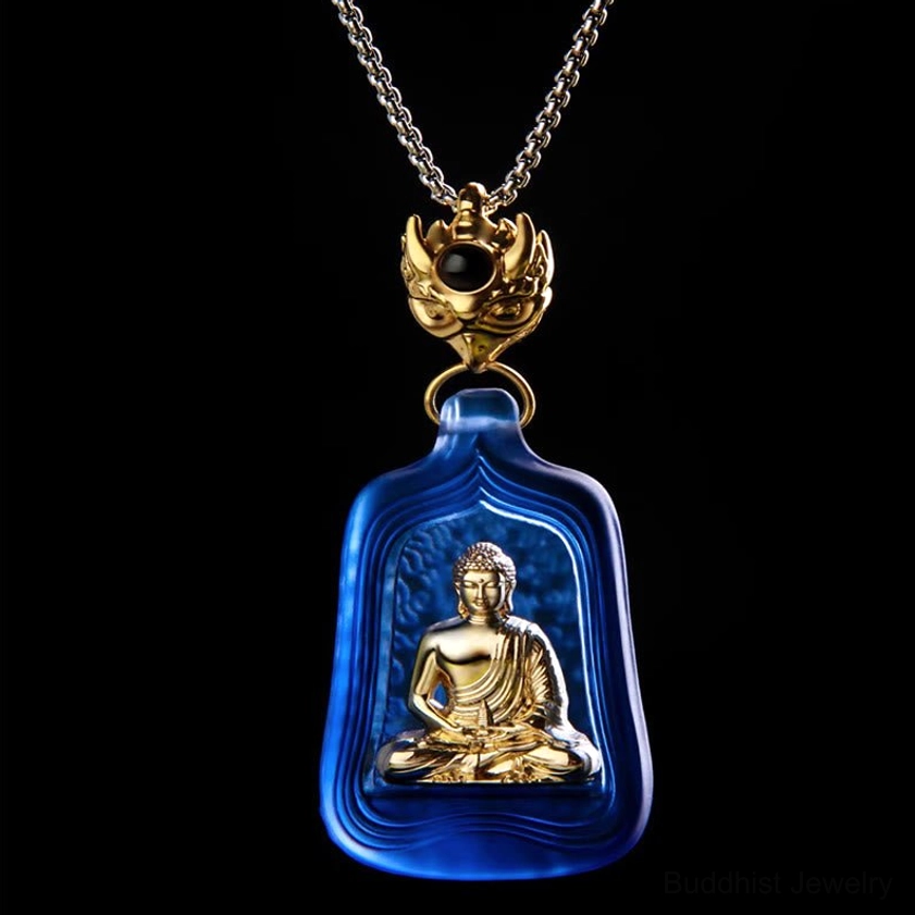 Medicine Buddha Buddhist necklace pendant in blue frosted glass with metal chain and black stone accent detail - overhead view