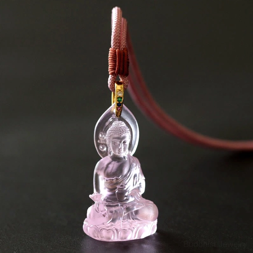 Pink Medicine Buddha Liuli crystal pendant close-up showing translucent rose-tinted glass and lotus base