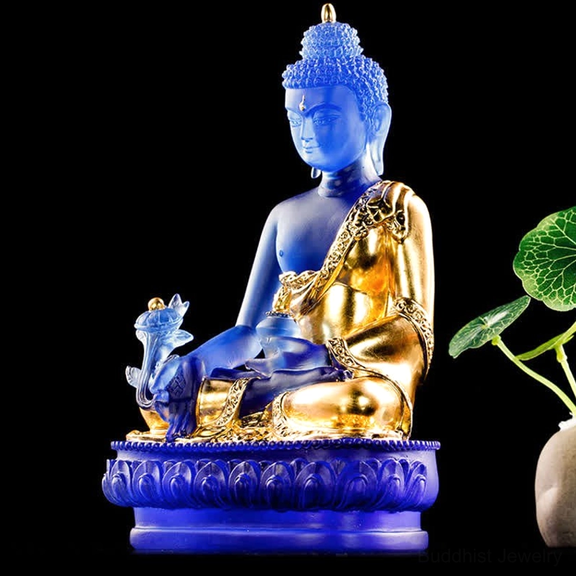 Medicine Buddha handmade Liuli glass sculpture front view pure white background, clear deep blue glass, gilded robe, matte finish