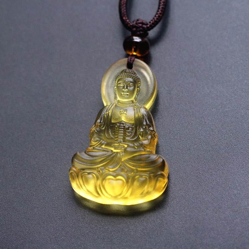 Amber yellow Liuli crystal Medicine Buddha necklace pendant with golden translucent glass and decorative brown beaded cord, compassion symbol jewelry