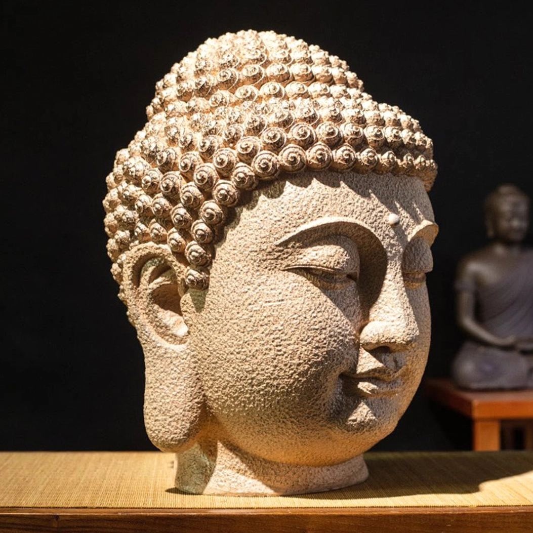 Meditating Buddha head resin statue three-quarter side view showing closed eyes and serene facial expression on wooden display shelf