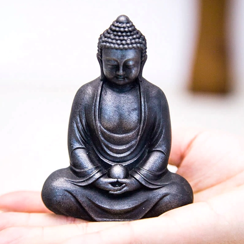 Meditating Buddha statue showing craftsmanship detail and natural material texture