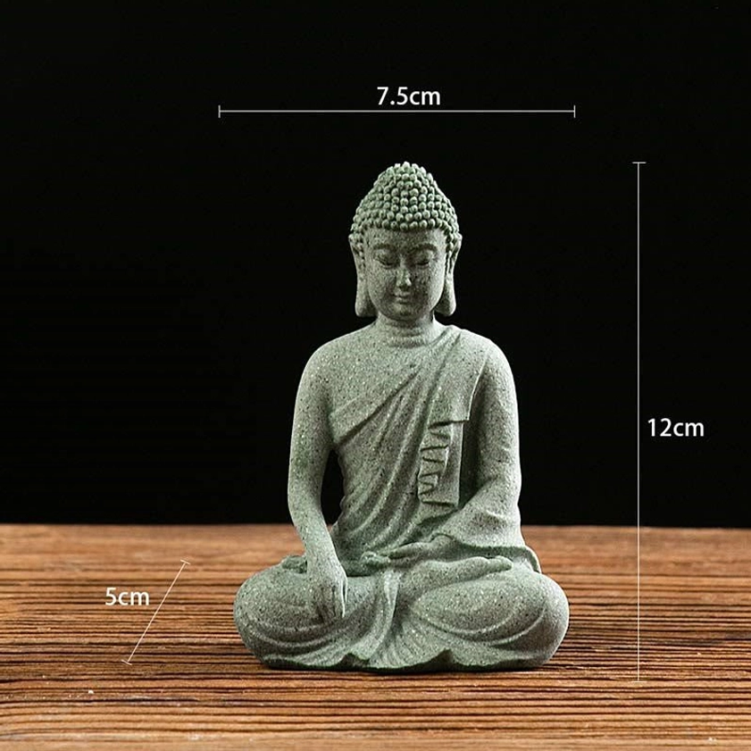 Meditating Buddha statue in lotus pose with hands resting on lap, natural green sandstone finish