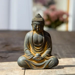 Meditating Buddha statue with cross-legged meditation pose, dark grey iron powder resin with rustic gold accents, held in hands detail