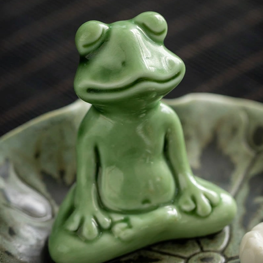 Meditating frog ceramic figurine in cross-legged pose on lotus leaf tray, glossy green glaze