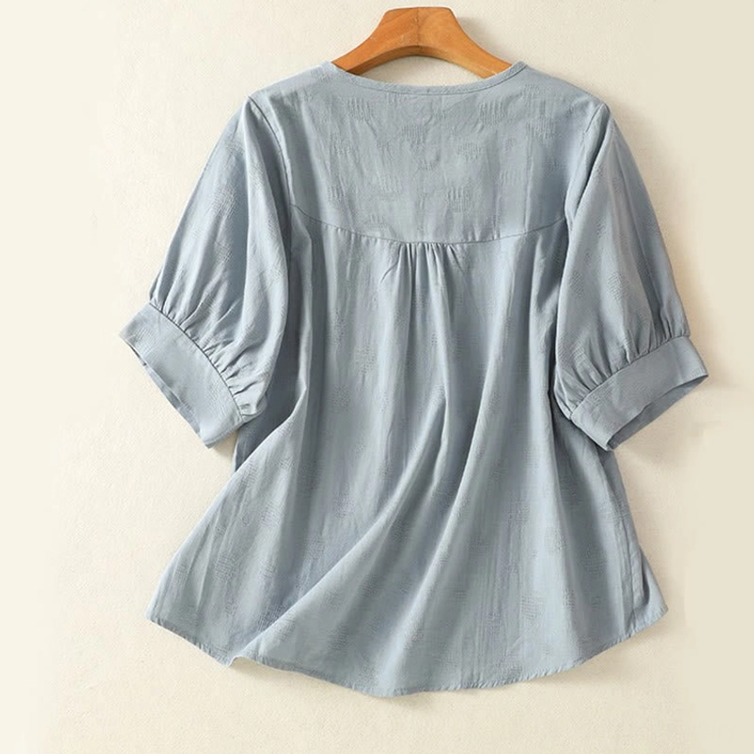 Light sky blue meditation blouse back view on hanger - showing gathered yoke and spiritual practice design