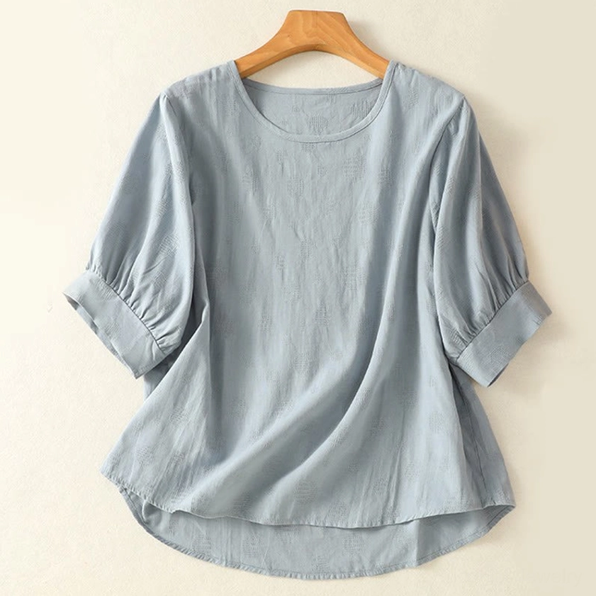 Light sky blue meditation blouse front view on hanger - crew neck short sleeve yoga top for spiritual practice