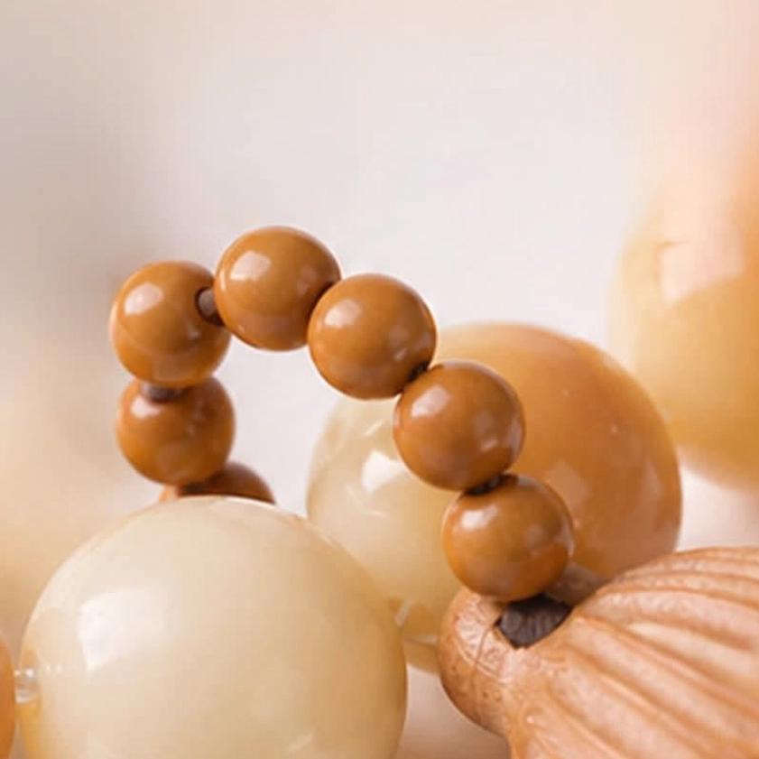 Bodhi seed meditation bracelet macro close-up showing round polished beads and wooden lotus charm