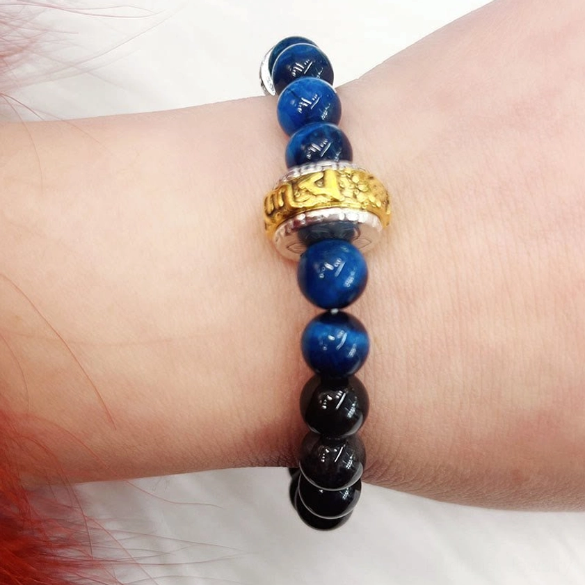 Meditation bracelet featuring silver sheen obsidian, blue tiger eye, and sacred Om mantra charm for spiritual practice