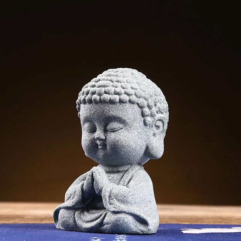 Meditating Buddha figurine three-quarter front view showcasing calm serene expression and matte grey stone texture