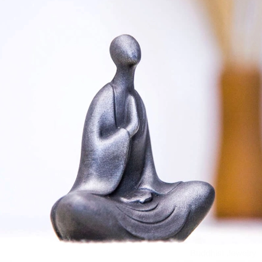 Meditation Buddha figurine in silvery-dark gray matte finish with clasped prayer hands and smooth sculpted form