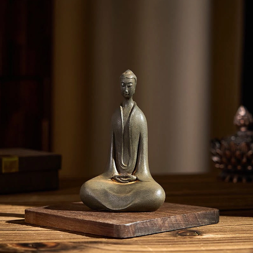 Meditating Buddha statue three-quarter view on wooden table with warm indoor ambiance