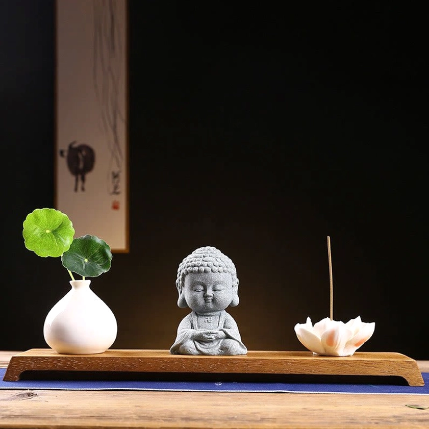 Meditation Buddha with wooden base and ceramic vase creating peaceful sanctuary for daily mindfulness practice