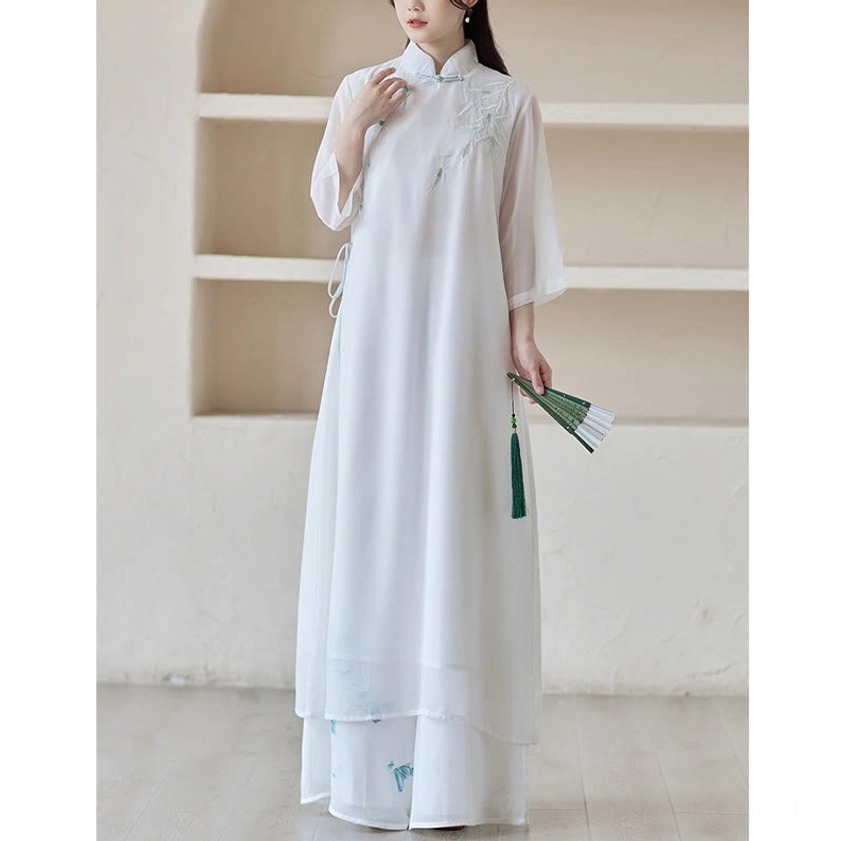 Buddhist-inspired practice clothing half-body front-side view of cheongsam dress with hand resting at collar, holding traditional folding fan