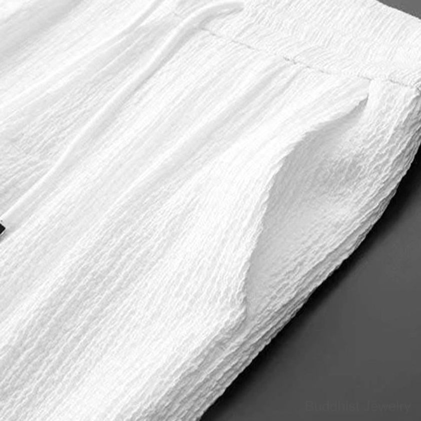 Lightweight crinkled linen fabric close-up texture, breathable meditation clothing material