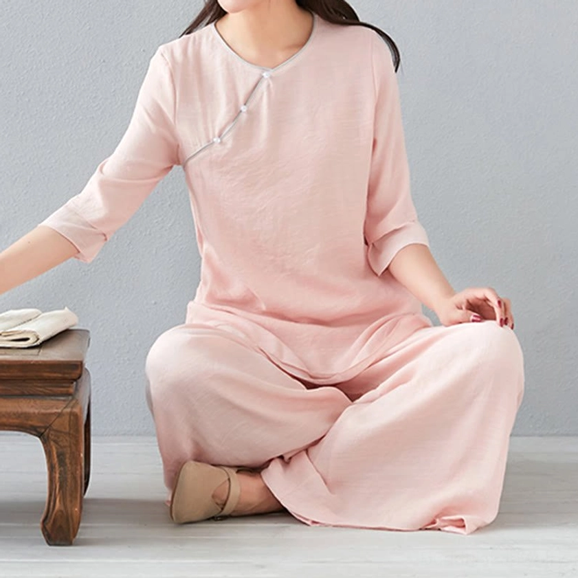 Back detail view of white meditation linen top showing simple crew neckline and three-quarter sleeve construction