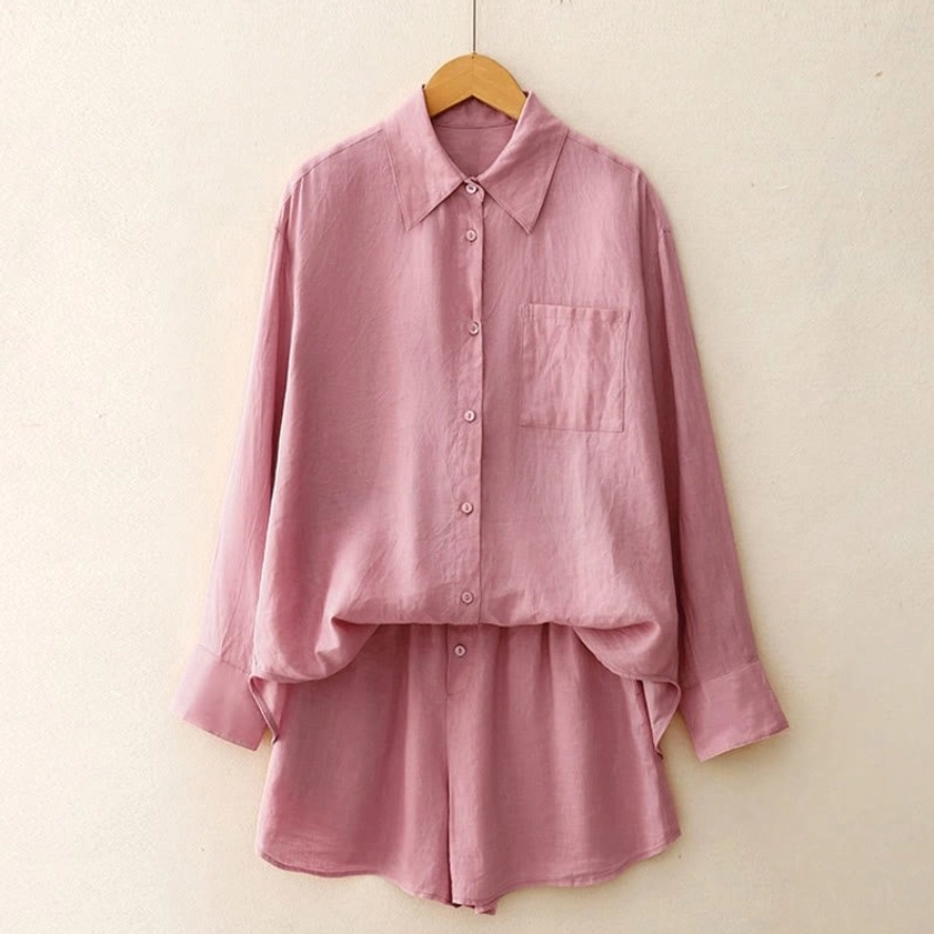Oversized dusty pink meditation loungewear two-piece set with relaxed fit long-sleeve shirt draped over matching shorts